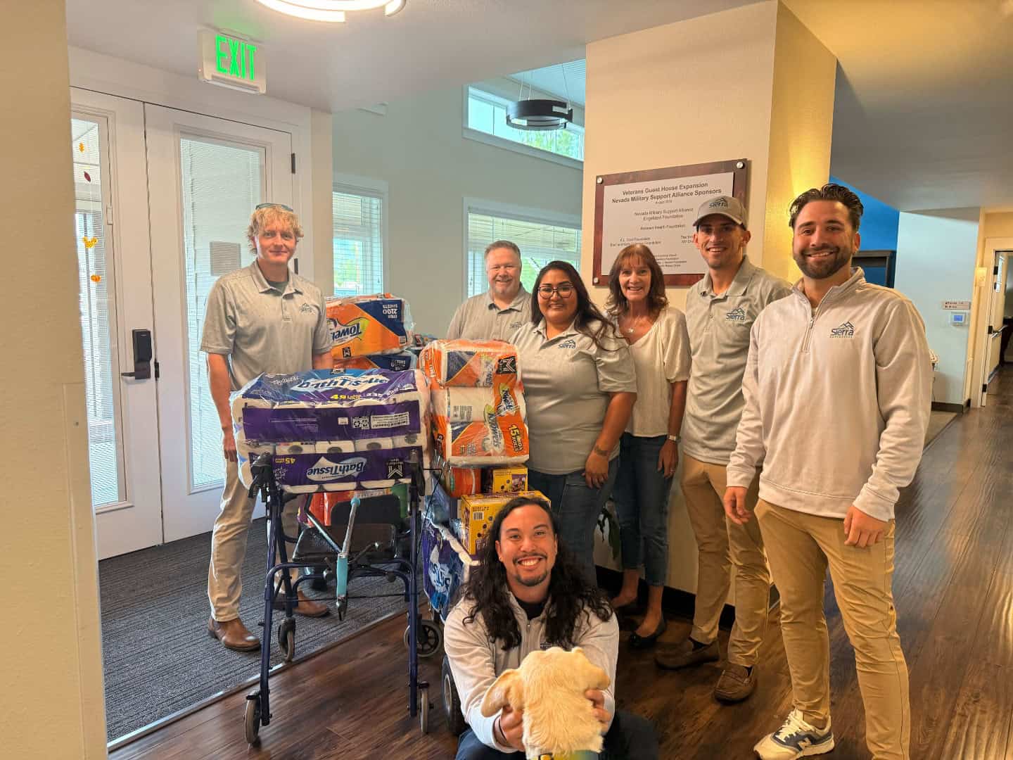 The Sierra Homebuyers team delivering a cart of household supplies inside the Veterans Guest House